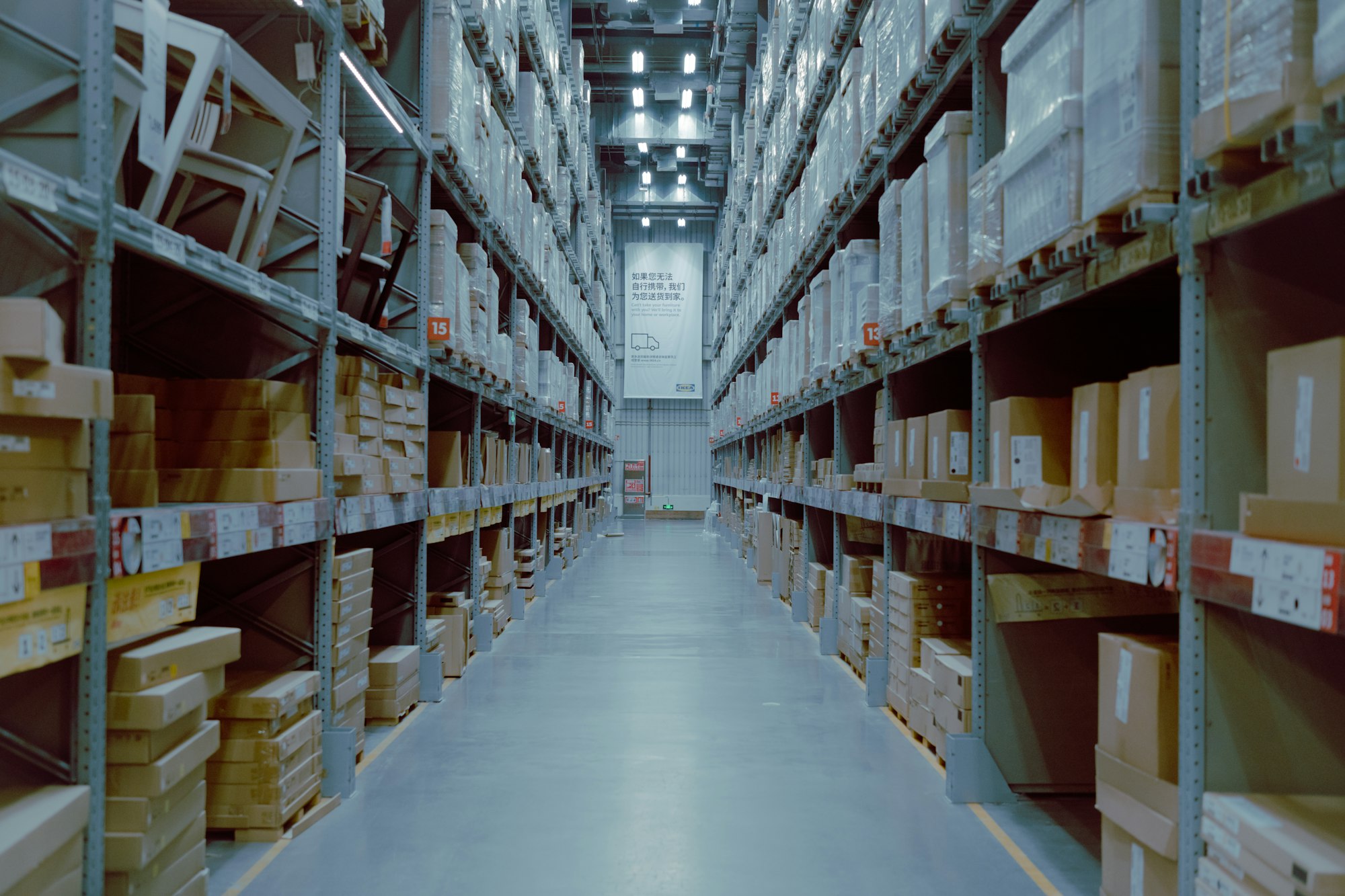 Forklift moving pallets between bays